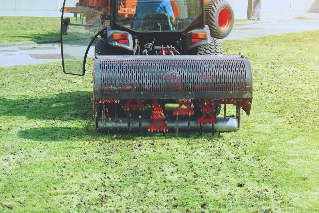 Lawn care specialist operating Soil Aerator