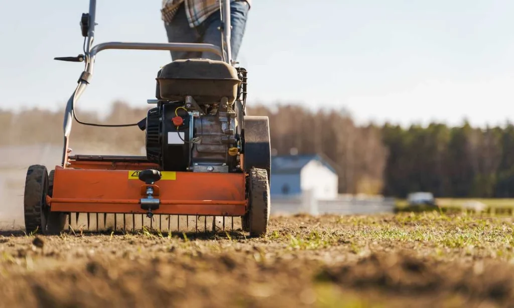 Specialist Using Aerator Machine on a Lawn